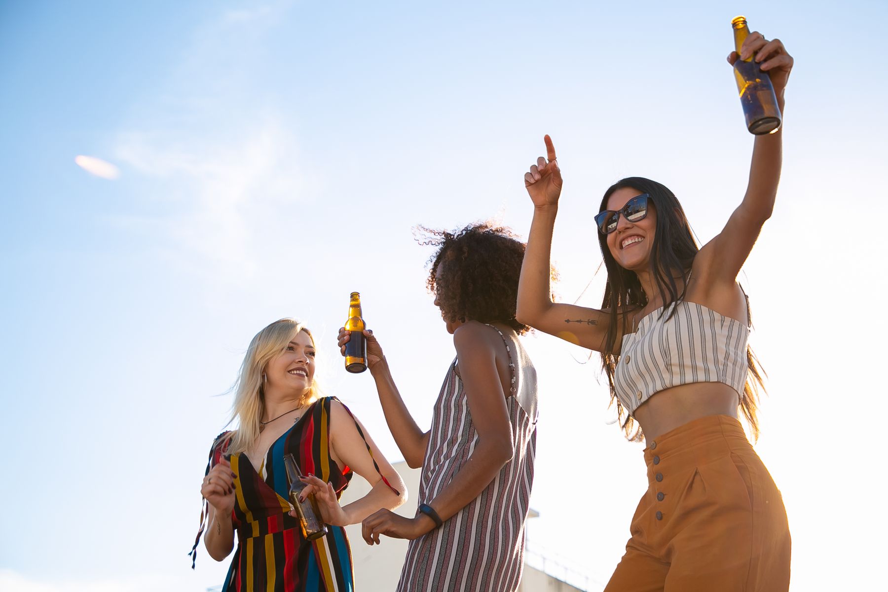 Hen party girls celebrating with drinks on a Lisbon rooftop